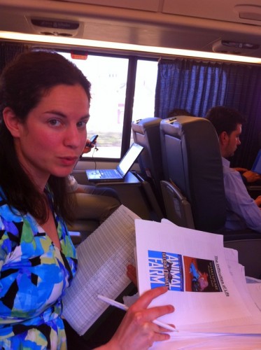 Grading papers as the train crosses liminal spaces.