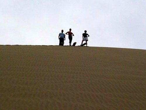 Ready to slide down, high atop the sand dune in Peru!