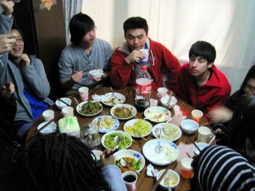 Eating a cozy dinner in a small Hutong house with friends.