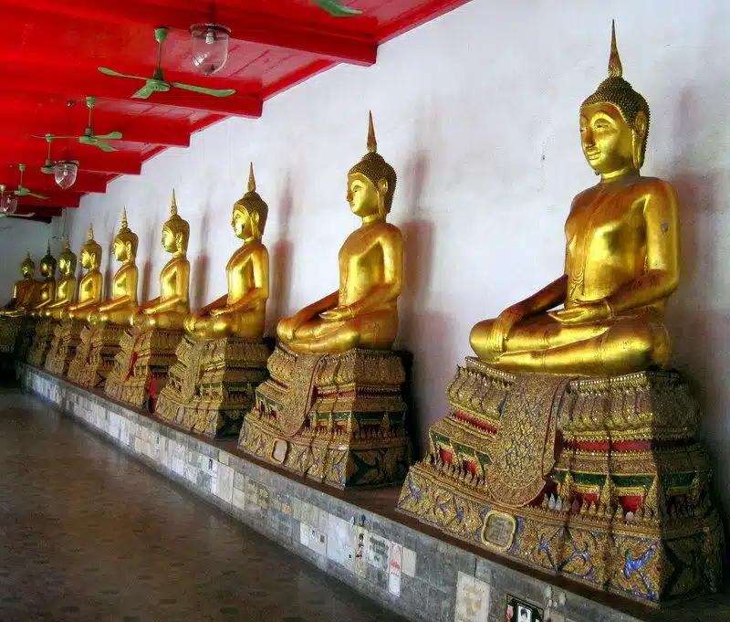 A row of golden statues at the Grand Palace.