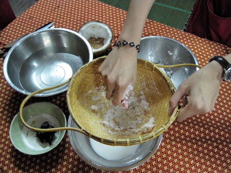 Mixing ingredients during Thai cooking class.