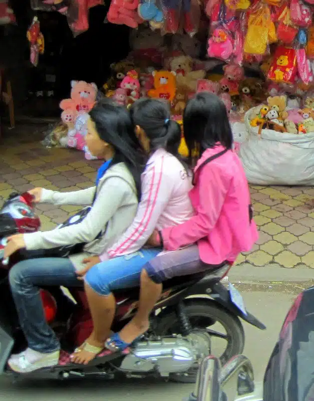 Three girls on a moto.