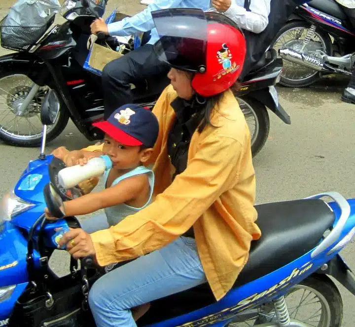 A baby on a motorcycle.