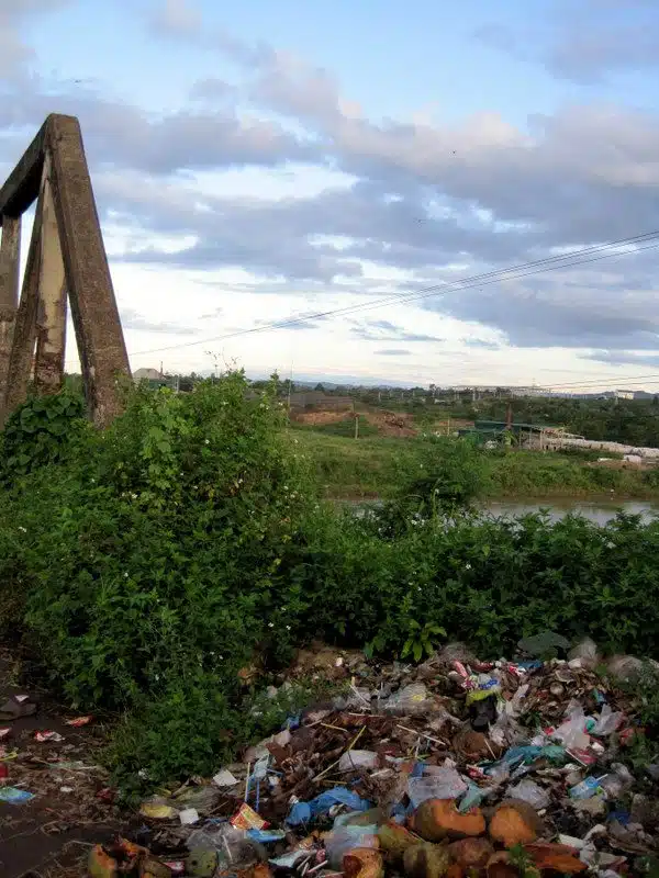 Trash by a bridge in Vietnam.