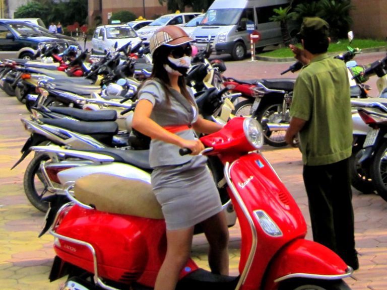 Riding to work in Vietnam by motorcycle.