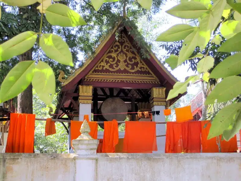 Orange monk robes hanging to air dry as laundry.