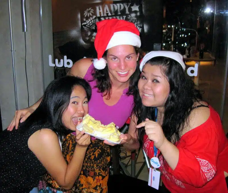 Eating durian with a Santa hat.