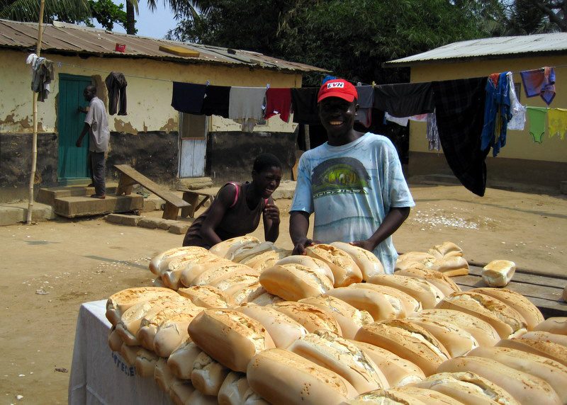 Selling bread by the road in Ghana.