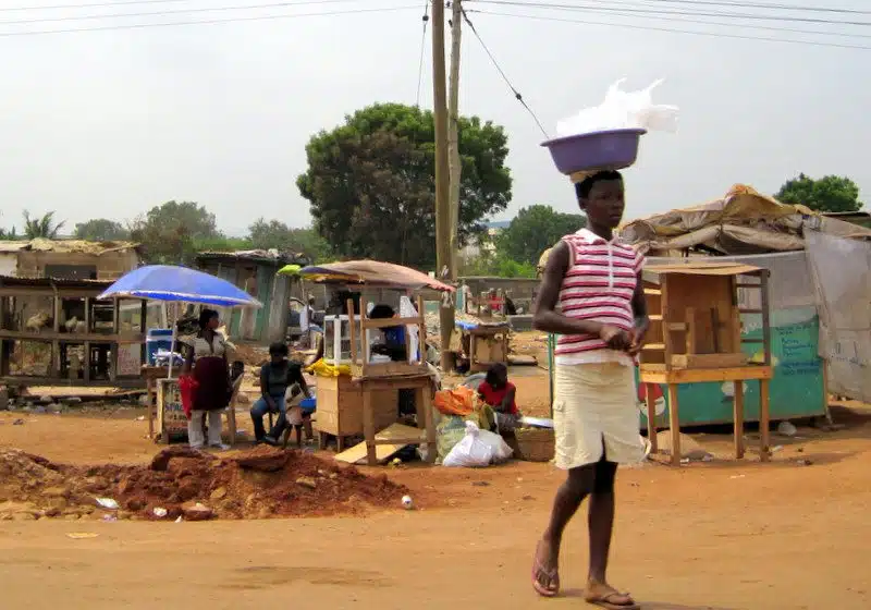 Balancing a basket on the head in a Ghana market.