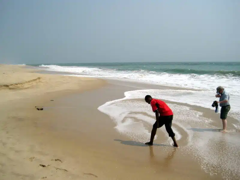 Swirling sea foam on the beach in Ghana.