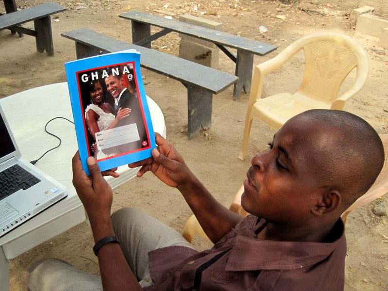 Obama on a workbook in Ghana.