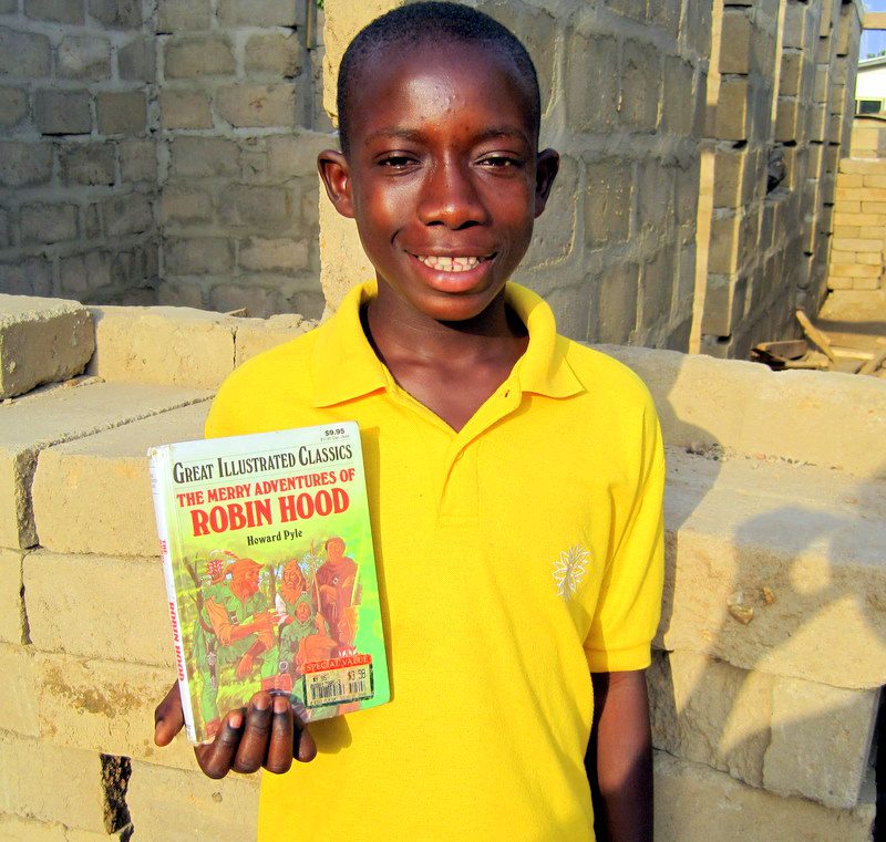 Elikem with a book he loves.
