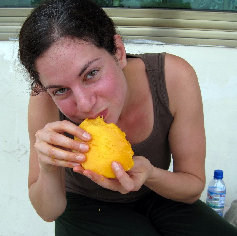Happily eating a mango.