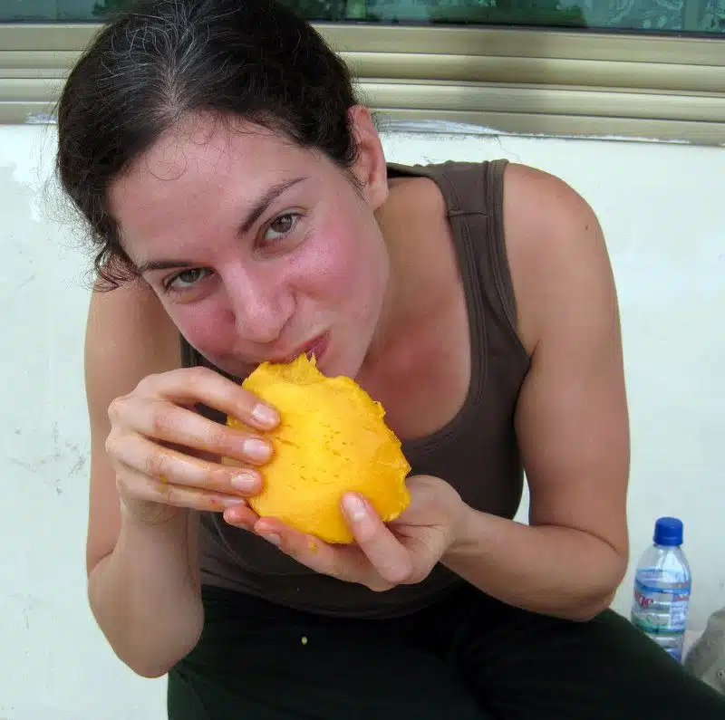 Happily eating a mango.
