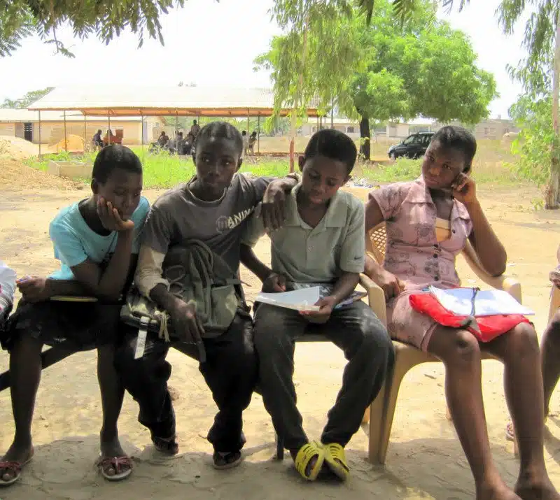 Doing schoolwork outside in Ghana.
