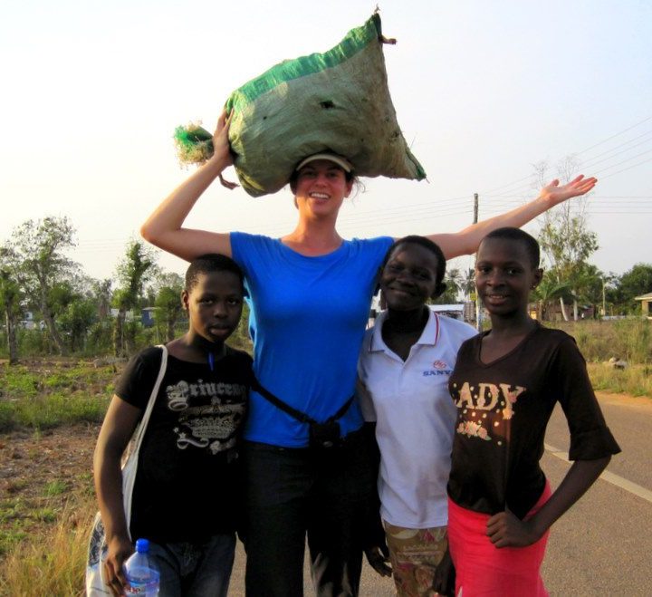 Me practicing carrying bags on my head with Ghanaian students.