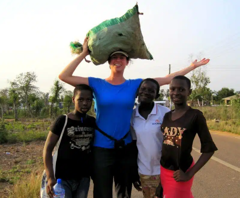 Me practicing carrying bags on my head with Ghanaian students.