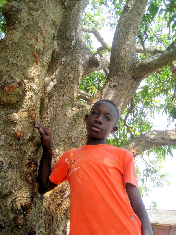 Elikem by a tree in Sogakope, Ghana.