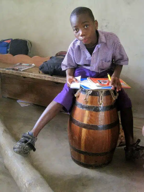 Using a drum as a makeshift desk in Ghana.