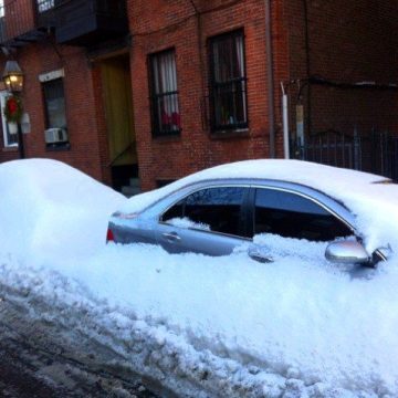 Snow-enveloped cars in Boston.