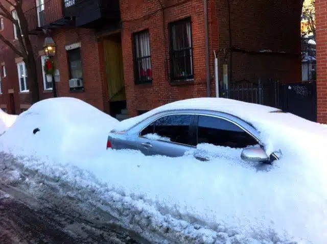 Snow-enveloped cars in Boston.