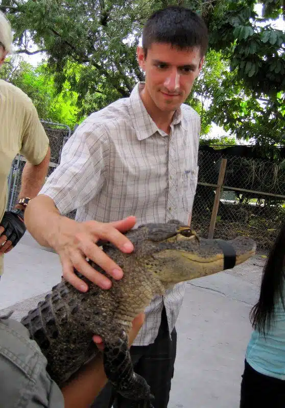 Colin carefully petting a baby alligator in the Everglades.