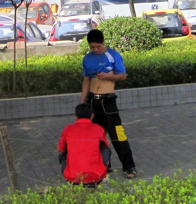 A man in Chongqing, China, displaying Naked Belly Fashion.