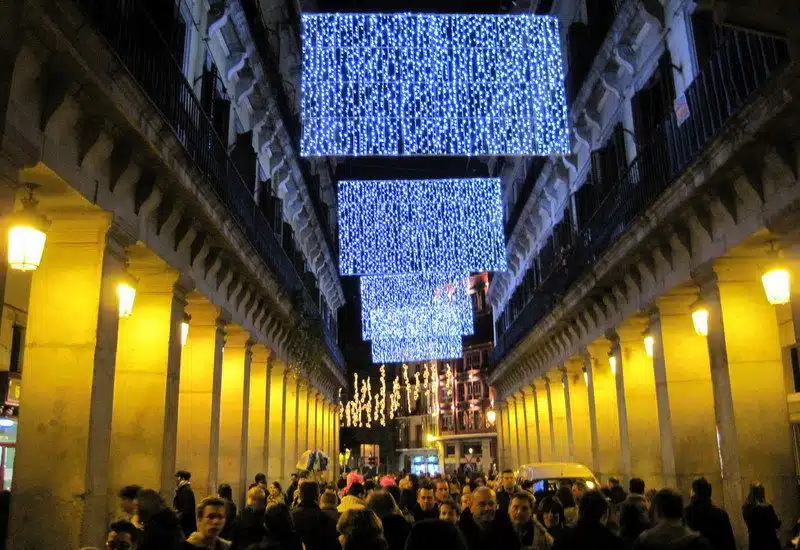 Spain's historic, packed streets are gilded with lights!