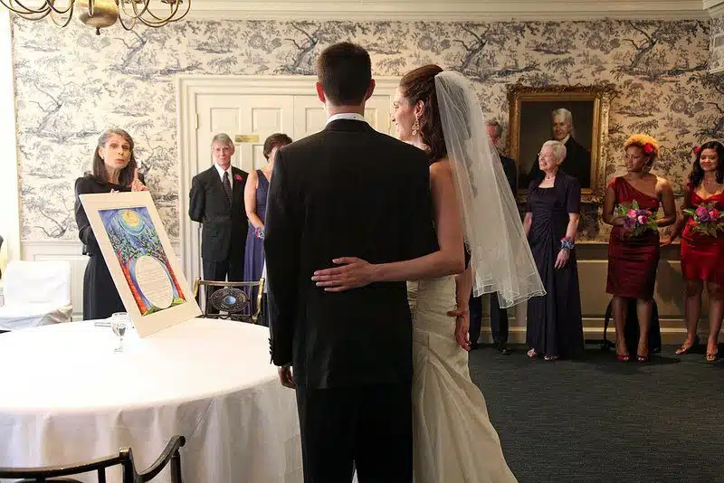 Admiring the ornate Ketubah as the Cantor tells the story behind it.