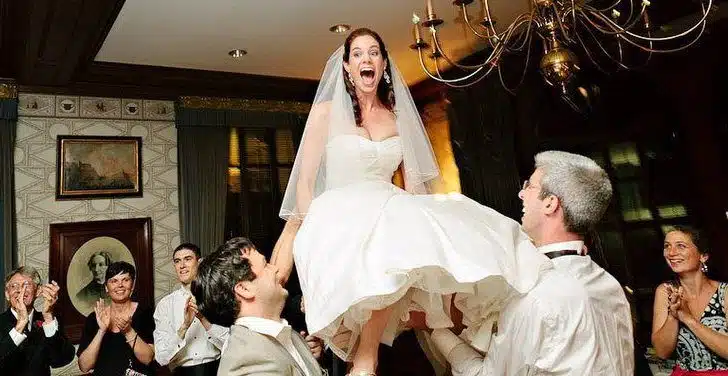 An awesome Jewish wedding tradition: The Bride and Groom are lifted on chairs during the Horah dance!