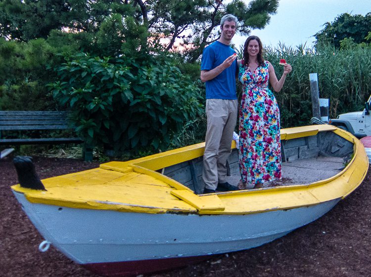 Eating watermelon with my "little" brother in a beached boat by Cape Cod greenery. 