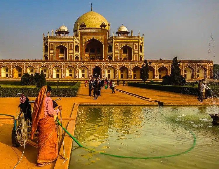 A female worker cleaning the fountain at the "Little Taj Mahal." 