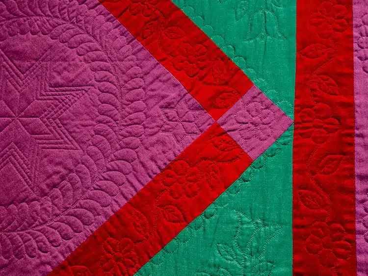 Check out the intricate stitching decorations on this quilt.