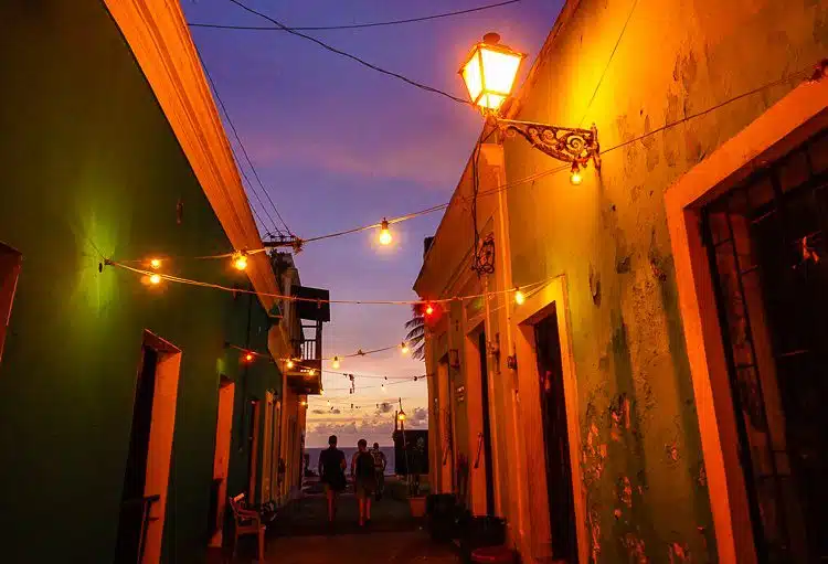 Old San Juan: At night, the color of the sunset purple sky dances with the lights and building walls.