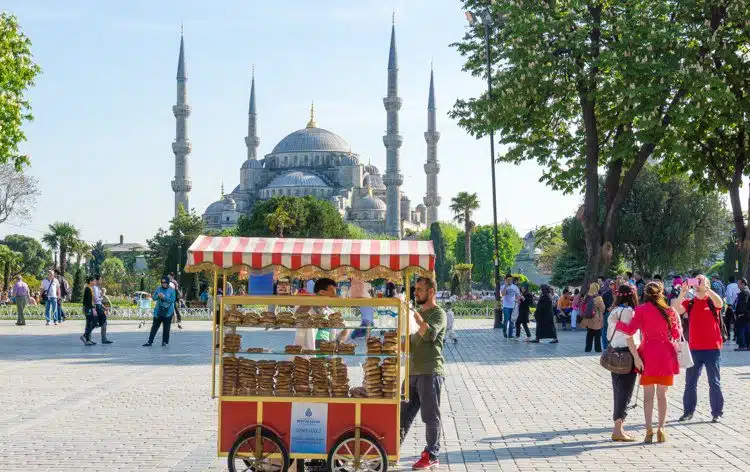 A man selling simit (like a Turkish bagel) outside the Blue Mosque.