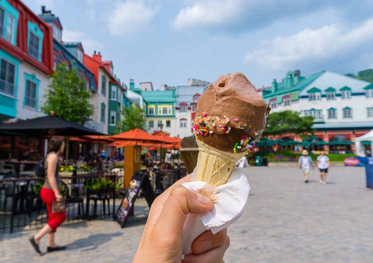 Creamy chocolate ice cream with the colorful town in back.