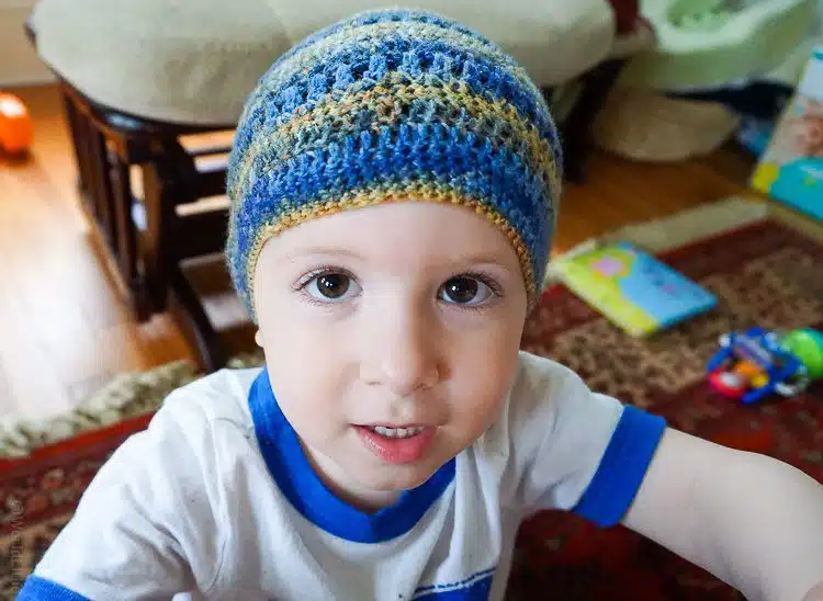 Our toddler modeling the hat his Daddy crocheted.