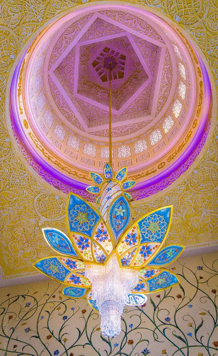 Geometric shapes in the chandelier and ceiling! The Sheikh Zayed Grand Mosque in Abu Dhabi, UAE is one of the most beautiful free tourist attractions in the world. Learn tips on visiting this amazing building.