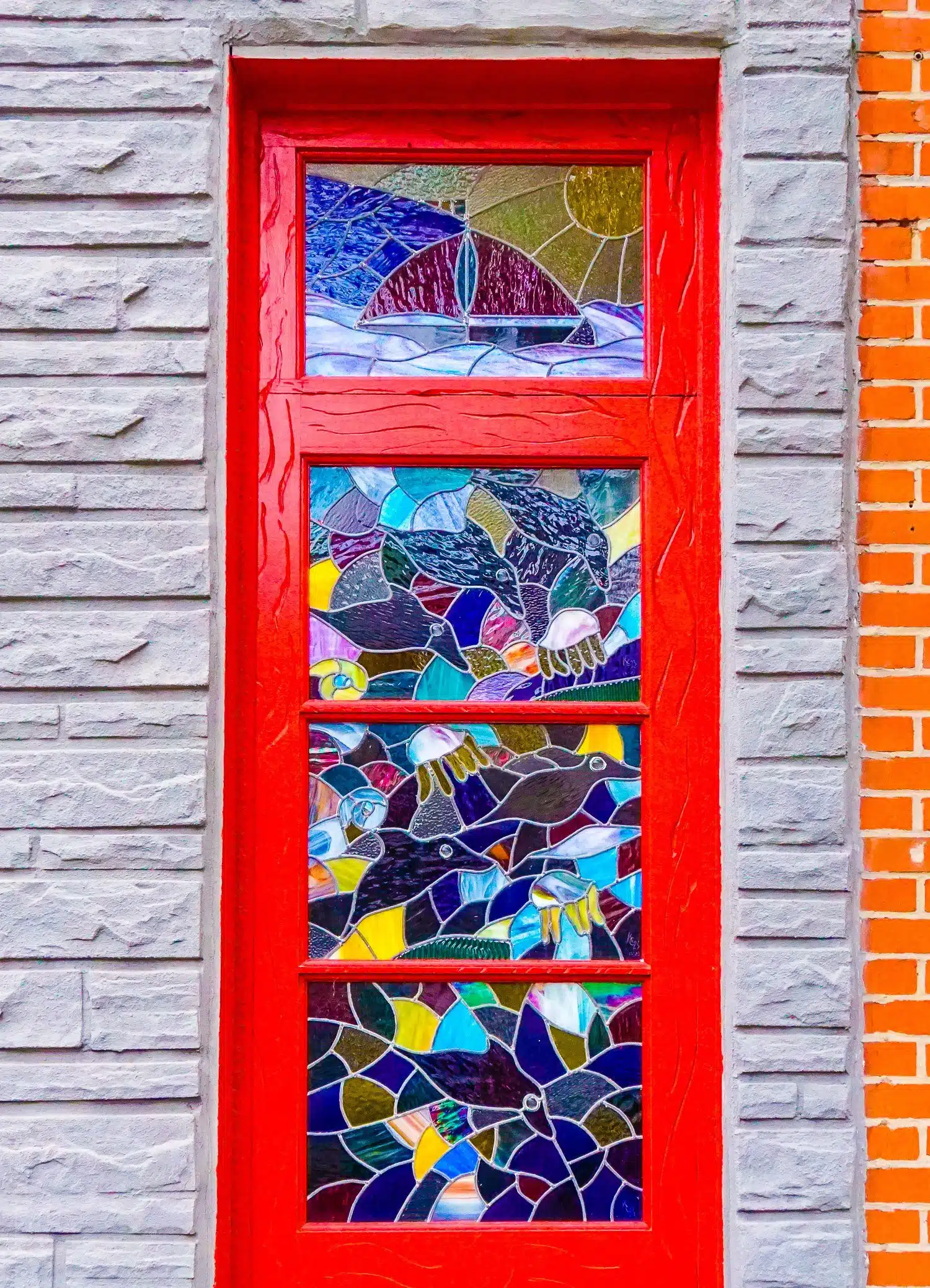 This beautiful red stained-glass door is a perfect example of why Fishtown, Philadelphia has some of the best public art in Philly!
