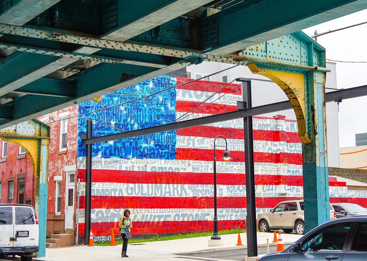 A flag mural, emblazoned with the names of local stores.