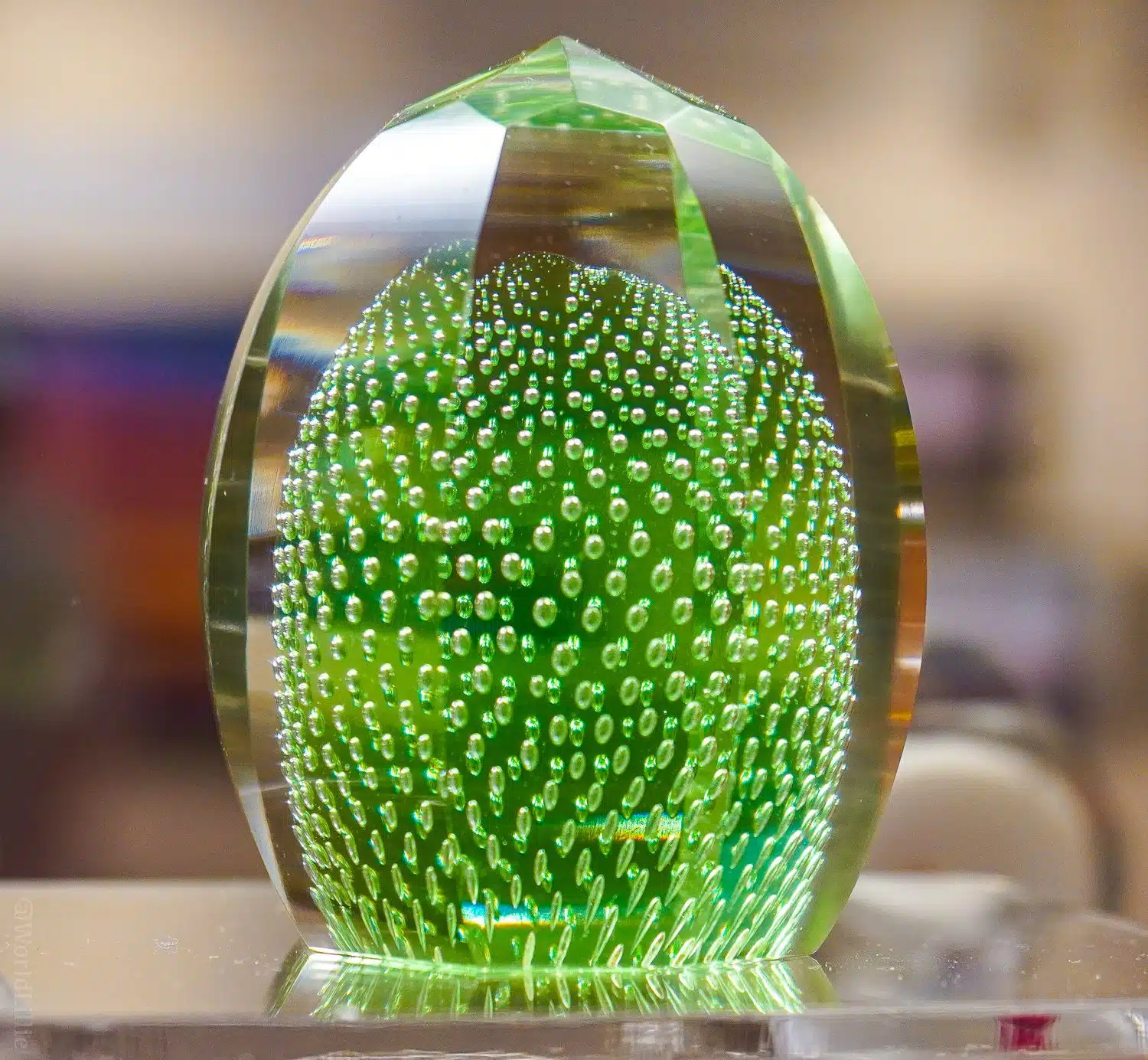 Bubbly green glass paperweight