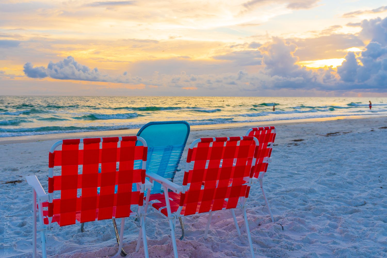 Beach chairs and soft sunset lighting.