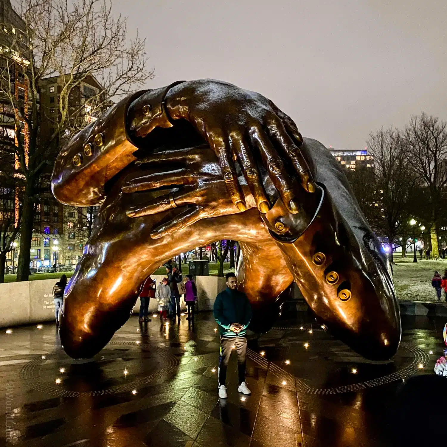 The Embrace sculpture at night.